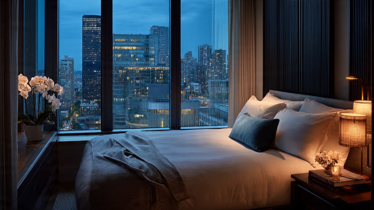 Luxury hotel suite at blue hour with city skyline view